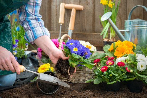Worker wearing PPE using gardening equipment